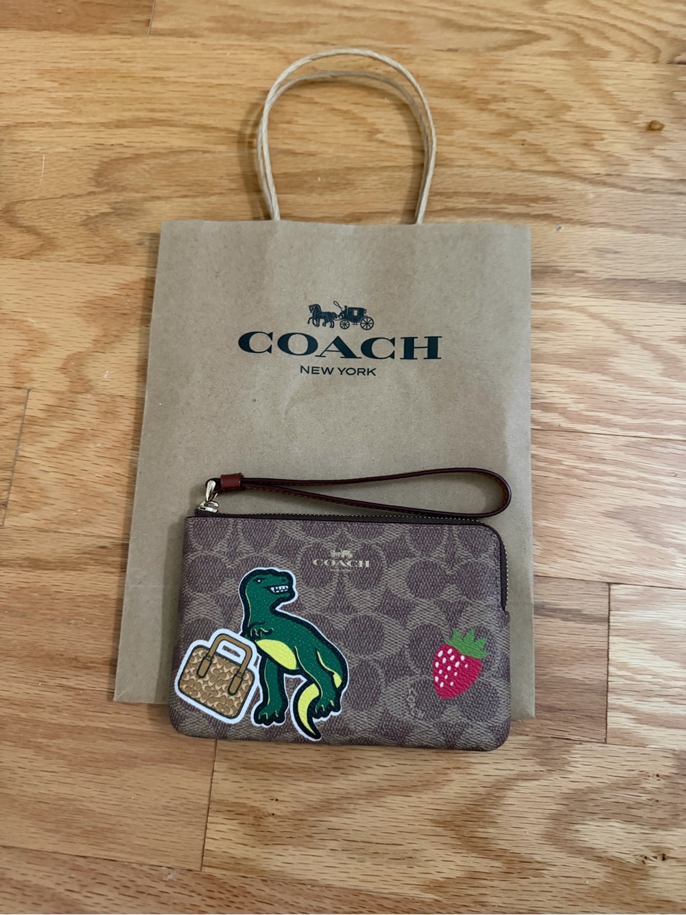 Coach Brown Signature Wristlet with Green Dinosaur & Red Strawberry Patches